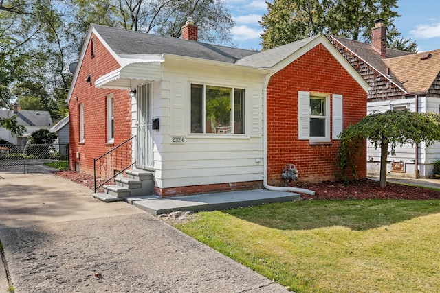 bungalow-style house with a front yard