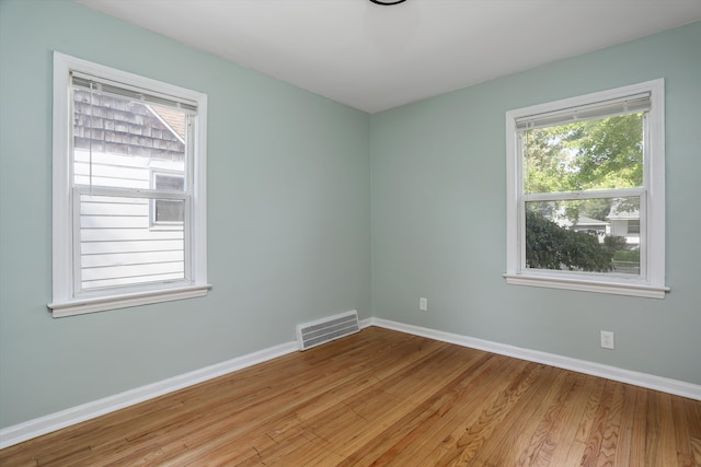 unfurnished room with light wood-type flooring