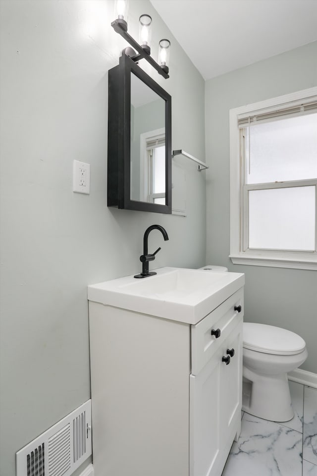 bathroom featuring vanity and toilet