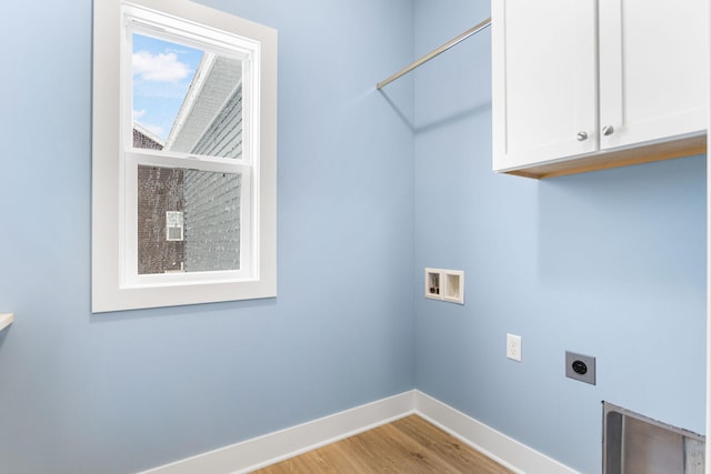 laundry room with hookup for an electric dryer, washer hookup, cabinets, and light hardwood / wood-style flooring