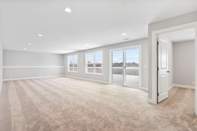 unfurnished living room featuring light carpet