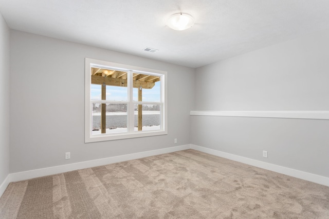 empty room featuring light carpet