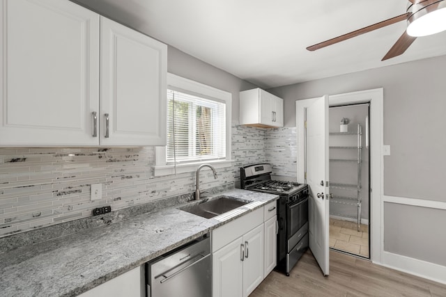 kitchen featuring decorative backsplash, stainless steel appliances, sink, light hardwood / wood-style flooring, and white cabinetry