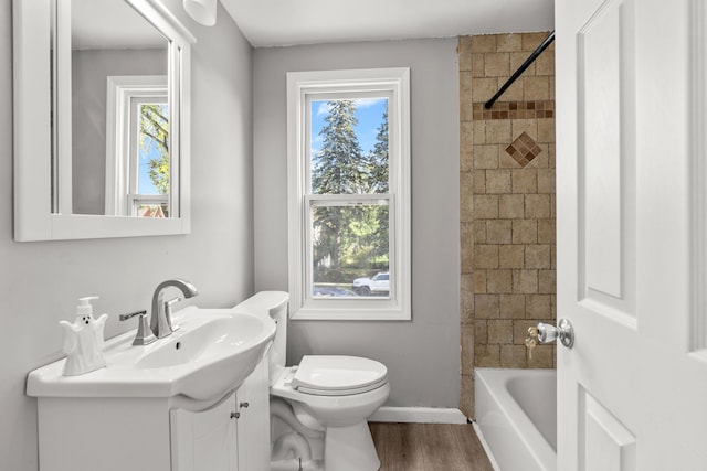 full bathroom with vanity, hardwood / wood-style flooring, toilet, and a healthy amount of sunlight