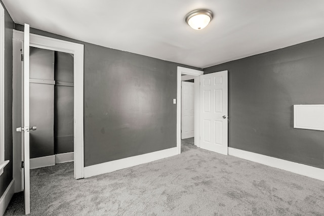 unfurnished bedroom featuring carpet flooring and a closet