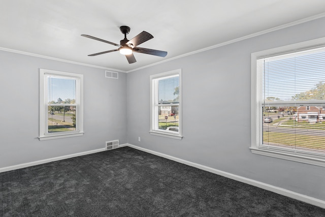 carpeted empty room featuring plenty of natural light, ceiling fan, and ornamental molding