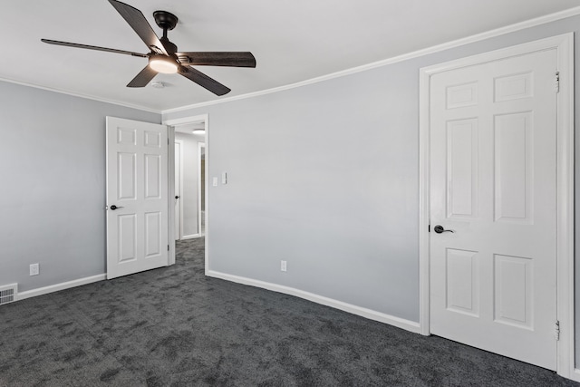 carpeted spare room with ceiling fan and ornamental molding