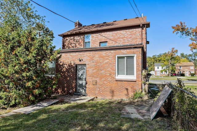 rear view of house with a yard