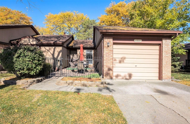 view of front of house with a front yard, a garage, and a patio area