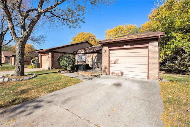 single story home with a front yard and a garage