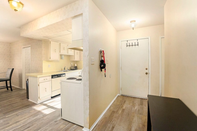 kitchen featuring white cabinets, white dishwasher, and light hardwood / wood-style flooring