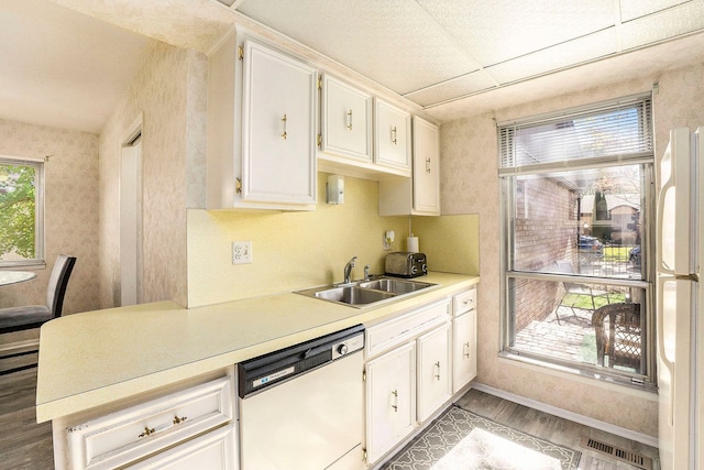 kitchen featuring white cabinetry, white appliances, sink, and light hardwood / wood-style flooring