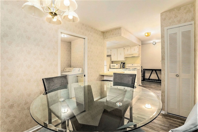 dining space with washing machine and dryer and hardwood / wood-style floors