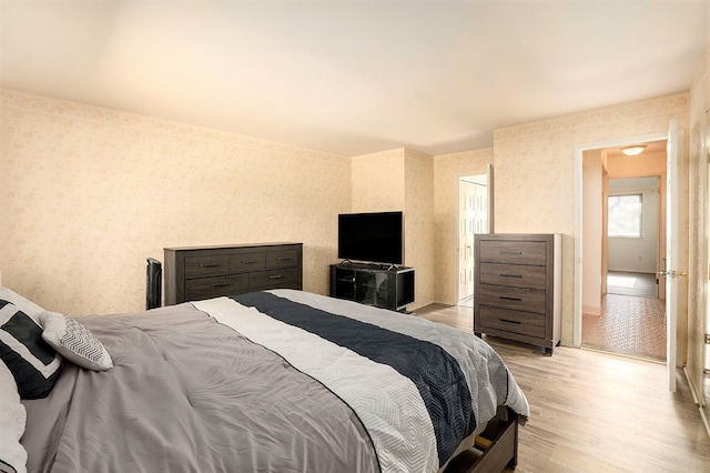 bedroom with light hardwood / wood-style flooring and a closet