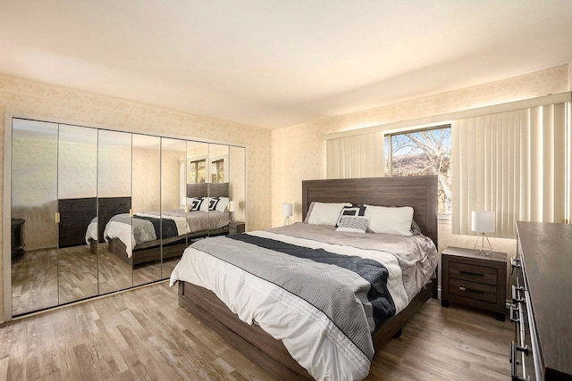 bedroom with hardwood / wood-style flooring and a closet