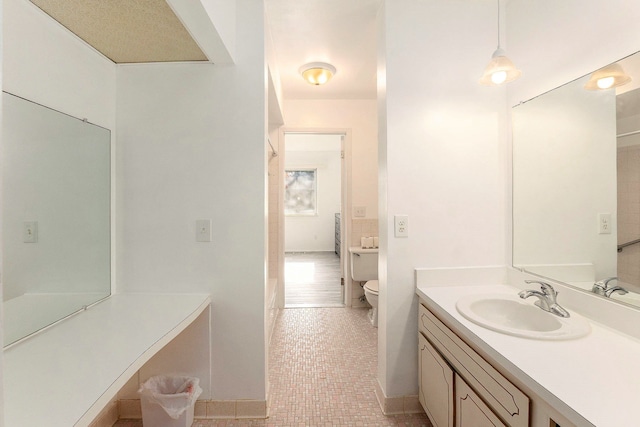 bathroom featuring toilet, vanity, and tile patterned floors