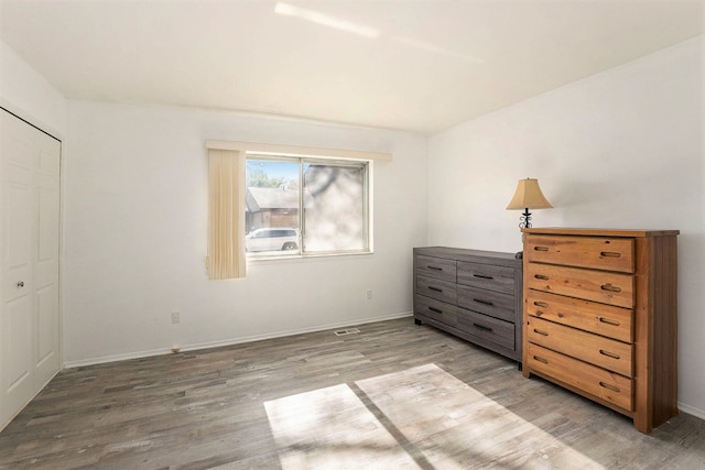 bedroom with a closet and hardwood / wood-style flooring