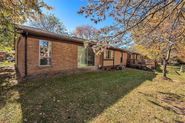 view of home's exterior featuring a yard and a deck