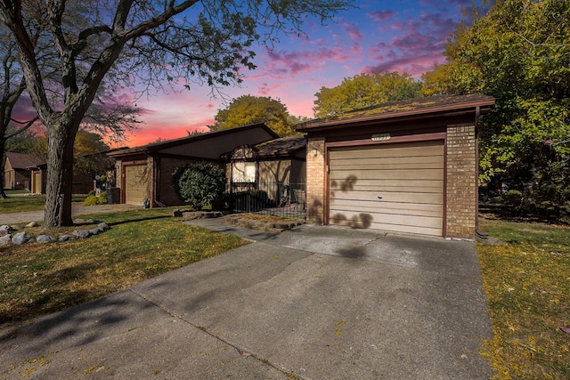 view of front of house with a garage and a yard