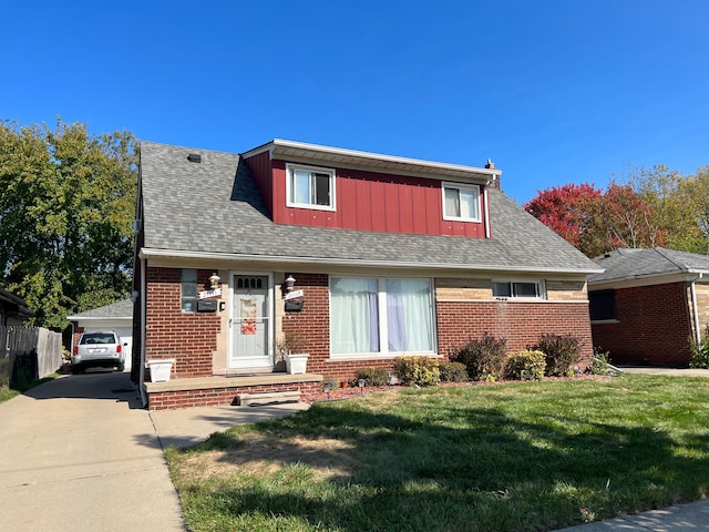 view of front of home with an outbuilding, a front lawn, and a garage