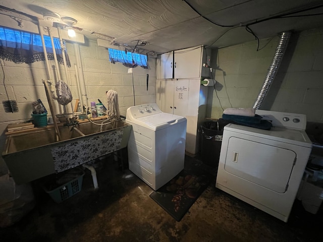 washroom with independent washer and dryer and sink