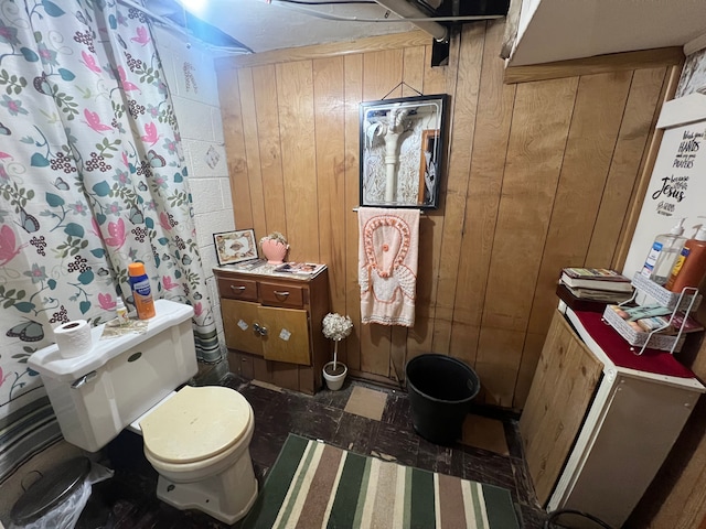 bathroom with toilet and wooden walls