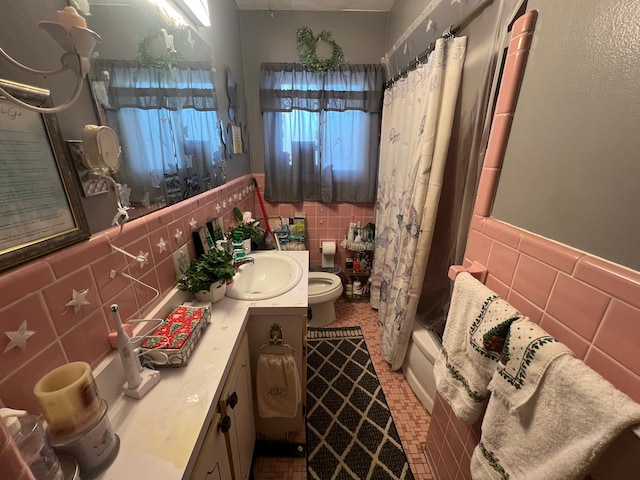 full bathroom with shower / tub combo with curtain, vanity, tile walls, and toilet