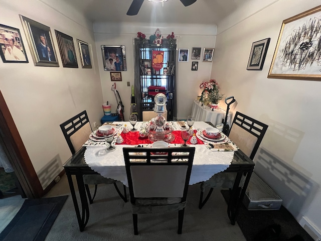 dining space featuring carpet flooring and ceiling fan