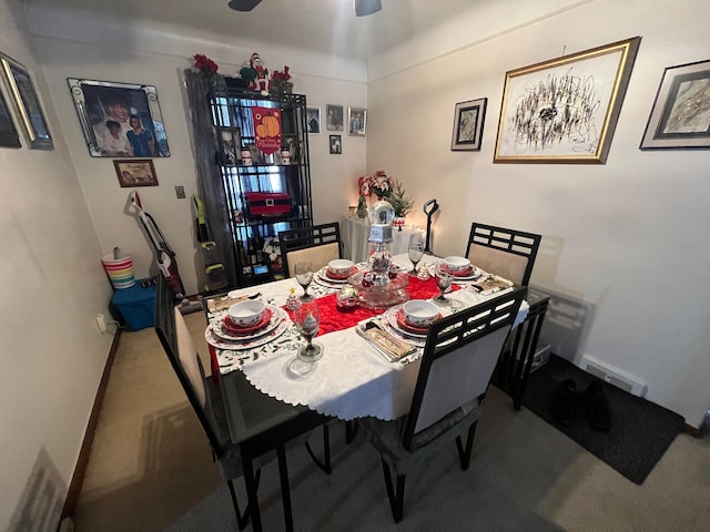 dining area featuring carpet flooring and ceiling fan