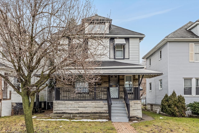 view of front facade featuring covered porch and a front yard