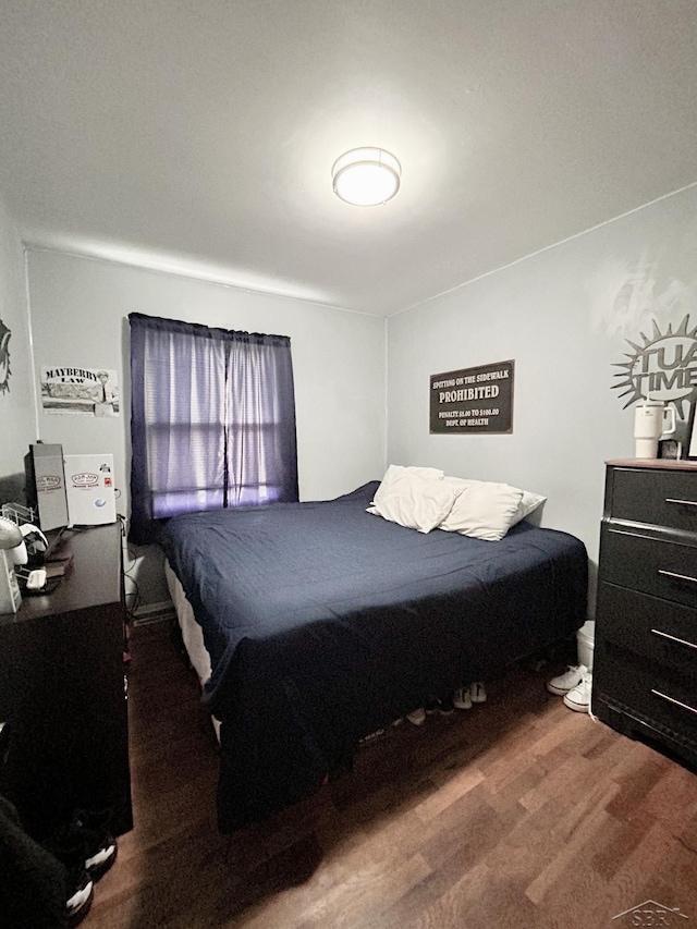 bedroom with hardwood / wood-style flooring