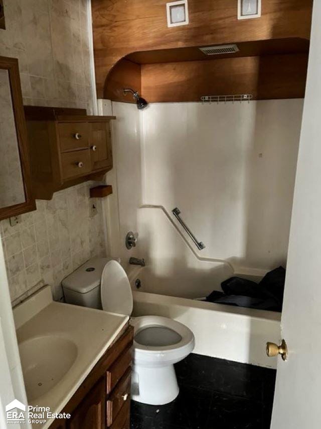 full bathroom featuring bathing tub / shower combination, vanity, tile walls, and toilet