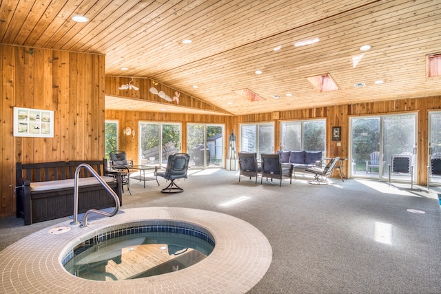 view of swimming pool featuring an indoor hot tub and a skylight