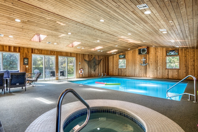 view of swimming pool featuring a skylight