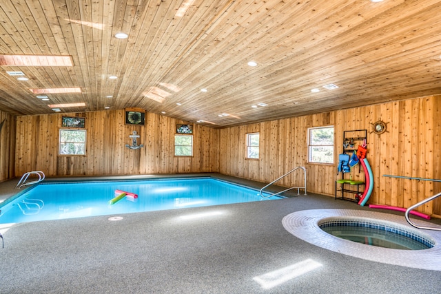 view of swimming pool featuring an indoor hot tub