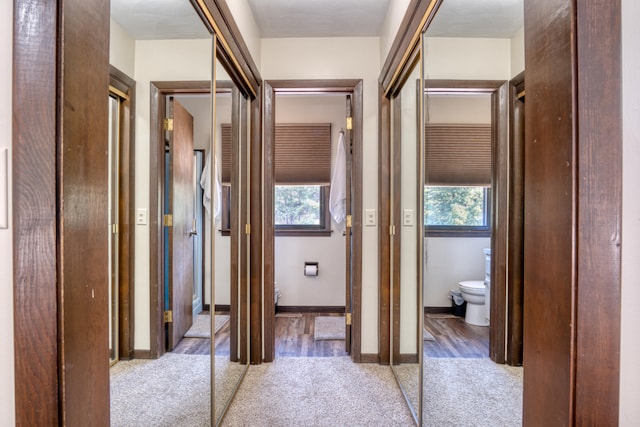 corridor with light hardwood / wood-style flooring