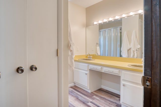 bathroom with hardwood / wood-style floors and vanity