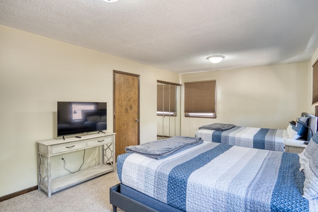 bedroom featuring carpet flooring and a textured ceiling