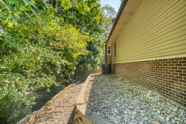 view of side of home with central air condition unit