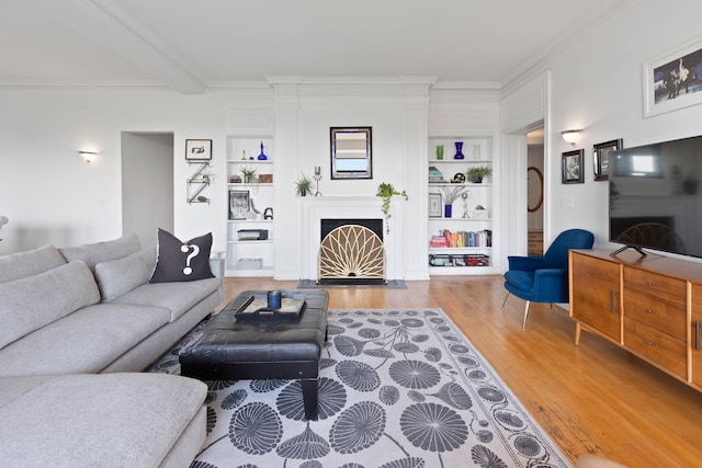 living room with beam ceiling, crown molding, built in features, and hardwood / wood-style flooring