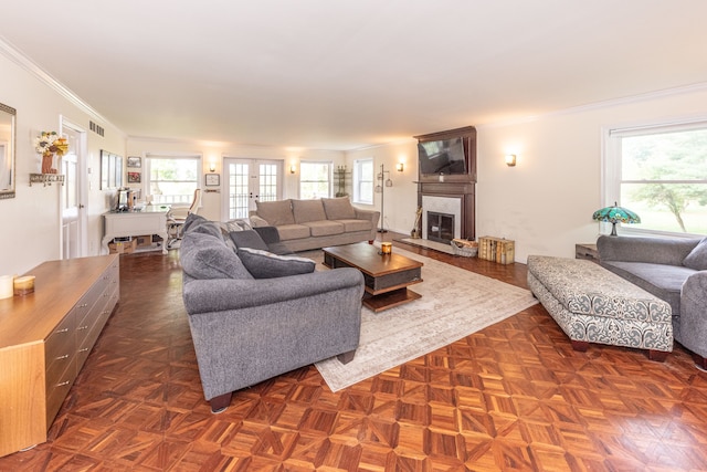 living room with ornamental molding, a high end fireplace, french doors, and visible vents