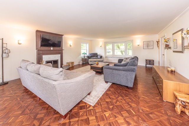 living area with a fireplace, baseboards, and crown molding