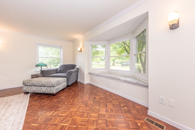 living area featuring baseboards, visible vents, and crown molding