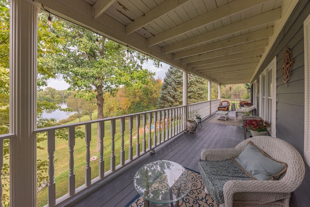 wooden deck featuring a water view