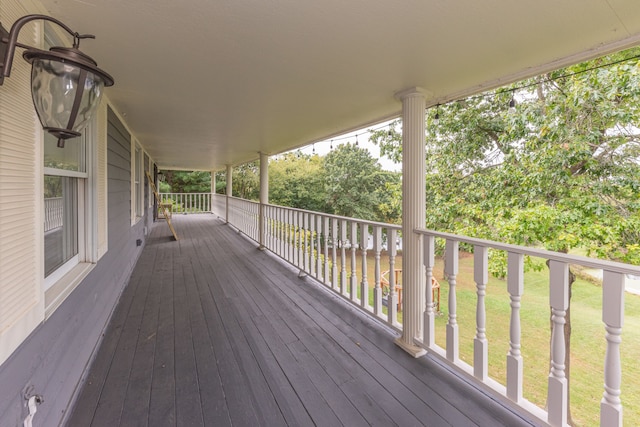 wooden terrace featuring a yard