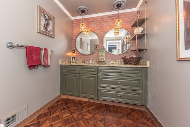 bathroom featuring ornamental molding, vanity, visible vents, and baseboards