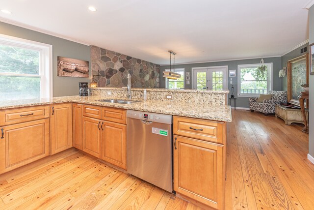 kitchen featuring crown molding, light wood-style floors, a sink, light stone countertops, and dishwasher