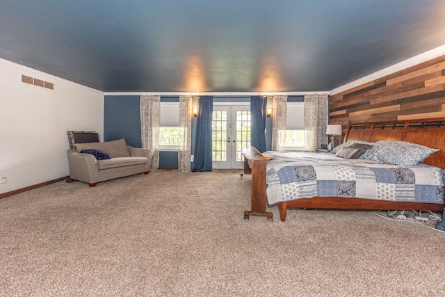 bedroom with carpet floors, french doors, visible vents, ornamental molding, and access to outside