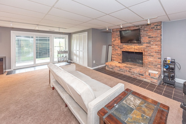 carpeted bedroom with a drop ceiling, a fireplace, baseboards, access to exterior, and track lighting