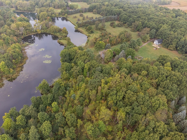 drone / aerial view featuring a water view and a forest view